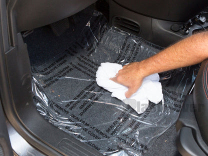 Detailer Uses Towel to Smooth Auto Film